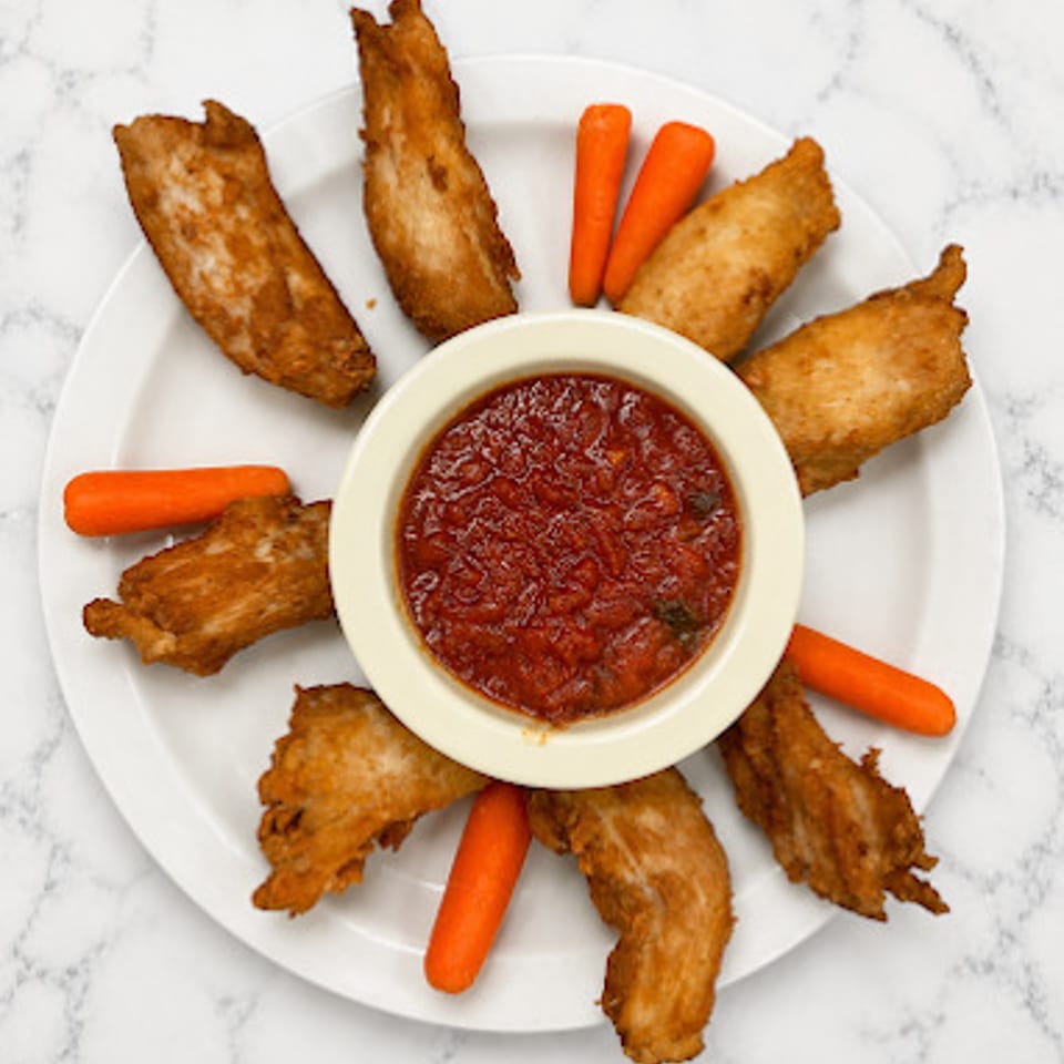 Vittoria wings with dipping sauce and carrots.